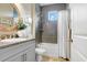 Bathroom features gray tiles, a shower over the tub, and modern fixtures at 6097 Golden Nettle Dr, Apollo Beach, FL 33572