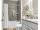 Well-lit bathroom featuring a granite countertop and tile shower with modern finishes at 6097 Golden Nettle Dr, Apollo Beach, FL 33572