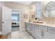Bathroom featuring double vanity with modern fixtures and bedroom view at 6097 Golden Nettle Dr, Apollo Beach, FL 33572