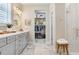 Bathroom featuring double vanity, storage, and an open closet at 6097 Golden Nettle Dr, Apollo Beach, FL 33572