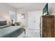 Bright bedroom featuring a comfortable chair and a mounted television at 6097 Golden Nettle Dr, Apollo Beach, FL 33572
