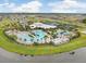 Aerial view of community amenities including pools, water slide, clubhouse, and recreation areas at 6097 Golden Nettle Dr, Apollo Beach, FL 33572
