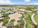 A wonderful community splash pad is surrounded by palm trees, a covered seating area, and a playground at 6097 Golden Nettle Dr, Apollo Beach, FL 33572