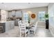 Dining area featuring modern table and chairs, pendant lighting, and window shutters at 6097 Golden Nettle Dr, Apollo Beach, FL 33572