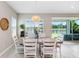 Dining room with views of outdoors and open floor plan to living area at 6097 Golden Nettle Dr, Apollo Beach, FL 33572