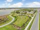 Aerial view of fenced dog park with walking trails, offering a great space for pets and owners at 6097 Golden Nettle Dr, Apollo Beach, FL 33572