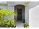Inviting entryway with a decorative wreath, potted plants, and a welcoming atmosphere at 6097 Golden Nettle Dr, Apollo Beach, FL 33572