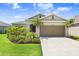 Lovely single-story home with lush landscaping, featuring palm trees and a well-maintained lawn at 6097 Golden Nettle Dr, Apollo Beach, FL 33572