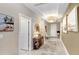 Bright hallway with decorative lighting, neutral walls, and a glimpse of the home's inviting interior at 6097 Golden Nettle Dr, Apollo Beach, FL 33572