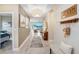Elegant hallway featuring a decorative light fixture, stylish decor, and an open view to the living area at 6097 Golden Nettle Dr, Apollo Beach, FL 33572