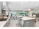 Open-concept kitchen featuring a large island, modern appliances, and a seamless connection to the dining area at 6097 Golden Nettle Dr, Apollo Beach, FL 33572