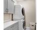 Efficient laundry room featuring gray cabinetry, a countertop, and stacked washer and dryer at 6097 Golden Nettle Dr, Apollo Beach, FL 33572