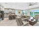 Open floor plan with kitchen, living, and dining areas, and access to outdoor view at 6097 Golden Nettle Dr, Apollo Beach, FL 33572