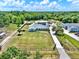 Aerial view displays a beautifully situated home with a large lawn, gated entrance, and long driveway at 6219 Wendell Dr, Wesley Chapel, FL 33544