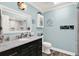 Bathroom with a vanity sink, marble countertop, and coastal-themed decor at 6219 Wendell Dr, Wesley Chapel, FL 33544