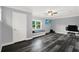 Bedroom with laminate flooring, a window seat and mounted television at 6219 Wendell Dr, Wesley Chapel, FL 33544