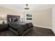 Bedroom with dark wood floors, a large window, and contemporary furnishings at 6219 Wendell Dr, Wesley Chapel, FL 33544