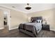 Cozy bedroom featuring hardwood floors, a ceiling fan, and a calming color scheme at 6219 Wendell Dr, Wesley Chapel, FL 33544