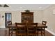 Dining room featuring hardwood floors, a wooden dining table with seating for six, and ample natural light at 6219 Wendell Dr, Wesley Chapel, FL 33544
