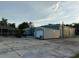 Metal building with roll-up doors and adjacent shed near a screened in pool at 6219 Wendell Dr, Wesley Chapel, FL 33544