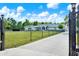 Charming home with well-manicured front yard, a long driveway, and a secure gated entrance at 6219 Wendell Dr, Wesley Chapel, FL 33544