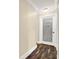 Hallway with decorative laundry room door and beautiful flooring at 6219 Wendell Dr, Wesley Chapel, FL 33544