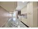 Well-lit laundry room featuring ample counter space, custom cabinets, and modern appliances at 6219 Wendell Dr, Wesley Chapel, FL 33544