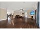 Open-concept living room featuring hardwood floors and a fireplace with large windows at 6219 Wendell Dr, Wesley Chapel, FL 33544