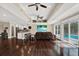 Open-concept living space with hardwood floors, views of the pool, and a modern aesthetic at 6219 Wendell Dr, Wesley Chapel, FL 33544