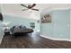 Well-lit main bedroom boasts wood flooring and a view of the pool at 6219 Wendell Dr, Wesley Chapel, FL 33544