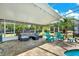 Spacious screened lanai featuring comfortable seating and lush greenery at 6219 Wendell Dr, Wesley Chapel, FL 33544
