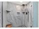 Modern tiled shower with sleek fixtures, built-in shelves, and glass enclosure at 6219 Wendell Dr, Wesley Chapel, FL 33544