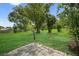 Well-maintained backyard with a mix of grass and landscaping at 6310 Gainsboro Ave, Spring Hill, FL 34609