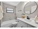 Updated bathroom with modern tiling, bathtub, and new vanity at 6310 Gainsboro Ave, Spring Hill, FL 34609