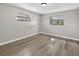 Clean bedroom with new vinyl floors, two windows, and a neutral wall color at 6310 Gainsboro Ave, Spring Hill, FL 34609