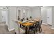 Nicely staged dining room featuring modern decor, sleek black chairs, and attractive wood flooring at 6310 Gainsboro Ave, Spring Hill, FL 34609