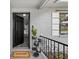 Front entrance with black door, welcome mat, and porch decor at 6310 Gainsboro Ave, Spring Hill, FL 34609