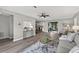 Open-concept living room with hardwood floors, modern decor, and lots of light at 6310 Gainsboro Ave, Spring Hill, FL 34609