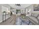 Spacious living room with wood flooring, gray walls, and neutral furnishings at 6310 Gainsboro Ave, Spring Hill, FL 34609