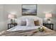 Comfortable main bedroom featuring a queen bed with decorative pillows and bedside tables at 6310 Gainsboro Ave, Spring Hill, FL 34609
