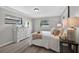 Well-lit main bedroom featuring a large window, dresser, and queen-sized bed at 6310 Gainsboro Ave, Spring Hill, FL 34609