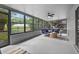 Spacious sun room with ceiling fan and large windows overlooking the yard at 6310 Gainsboro Ave, Spring Hill, FL 34609