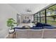 Well-lit screened-in sun room with comfortable seating and views at 6310 Gainsboro Ave, Spring Hill, FL 34609