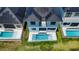 New construction home boasts a sparkling pool and patio with outdoor living space on a beautiful manicured lawn at 6530 Simone Shores Cir, Apollo Beach, FL 33572