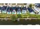 An aerial view features four modern waterfront homes with in-ground pools and private docks at 6530 Simone Shores Cir, Apollo Beach, FL 33572