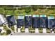 An aerial view features four modern homes with dark roofs and adjacent in-ground pools on the water at 6530 Simone Shores Cir, Apollo Beach, FL 33572