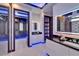 Modern bathroom with a glass shower, dual vanities, sleek finishes, and a separate walk-in closet at 6530 Simone Shores Cir, Apollo Beach, FL 33572