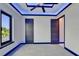 Bedroom featuring modern blue trim, stylish doors, and ample natural light at 6530 Simone Shores Cir, Apollo Beach, FL 33572