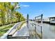 Private dock features a boat lift, providing convenient access to waterways and waterfront activities at 6530 Simone Shores Cir, Apollo Beach, FL 33572