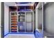 Spacious walk-in closet with custom shelving, drawers, and ample storage solutions in a well-lit space at 6530 Simone Shores Cir, Apollo Beach, FL 33572